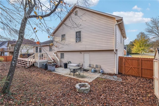 back of property featuring a deck and a patio area