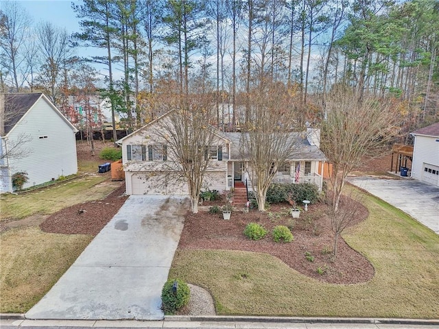 view of front of property featuring a porch, a front yard, and a garage