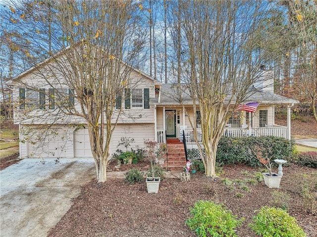 split level home with covered porch and a garage