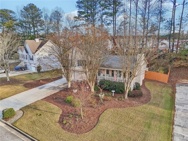 view of front of house with a front lawn, a porch, and a garage