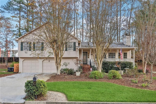 split level home with a front yard, a porch, and a garage