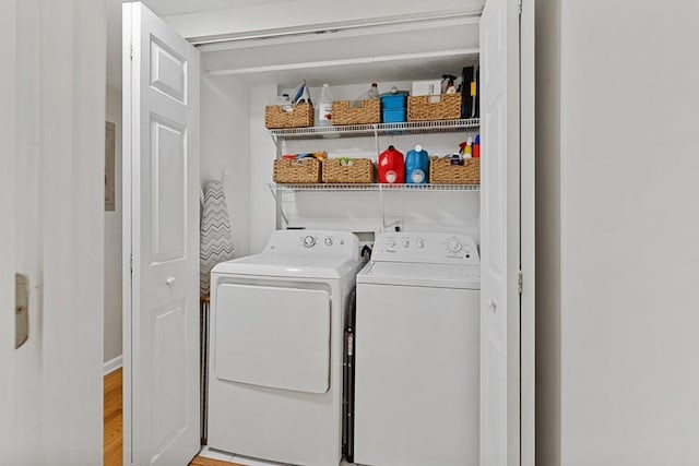 laundry area featuring washing machine and dryer, laundry area, and light wood-type flooring