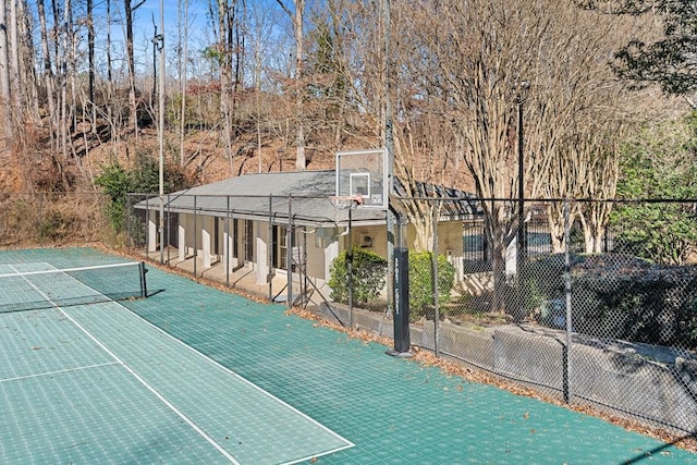 view of basketball court featuring a tennis court and fence