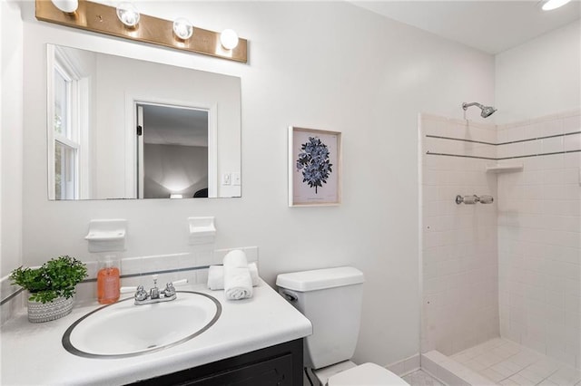 3131 Garden Lane Dr, Marietta, GA 30062 - bathroom featuring toilet, vanity, and a tile shower