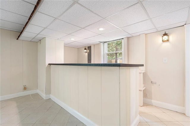 3131 Garden Lane Dr, Marietta, GA 30062 - basement with tile patterned floors, bar area, a drop ceiling, baseboards, and a decorative wall