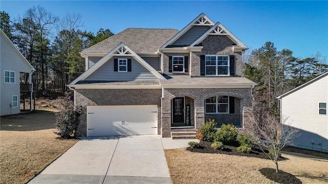 craftsman inspired home featuring a front yard and a garage