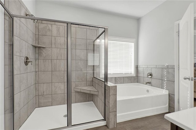 bathroom featuring independent shower and bath