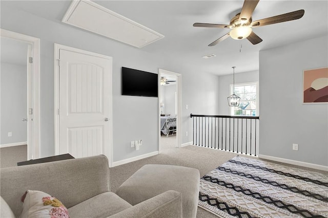 sitting room with carpet flooring and ceiling fan