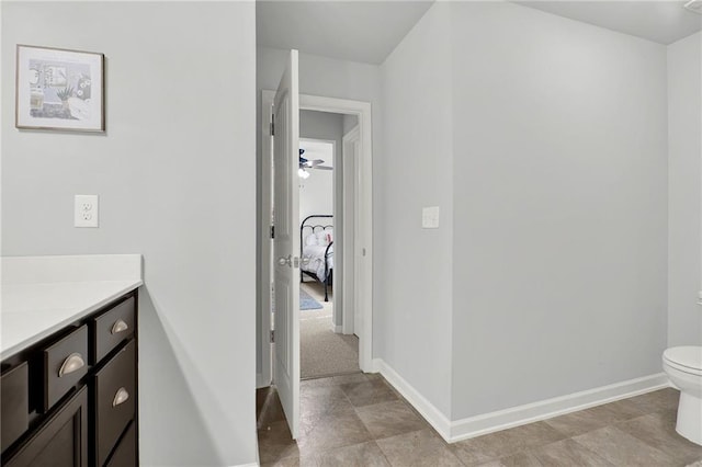 bathroom with ceiling fan, toilet, and vanity