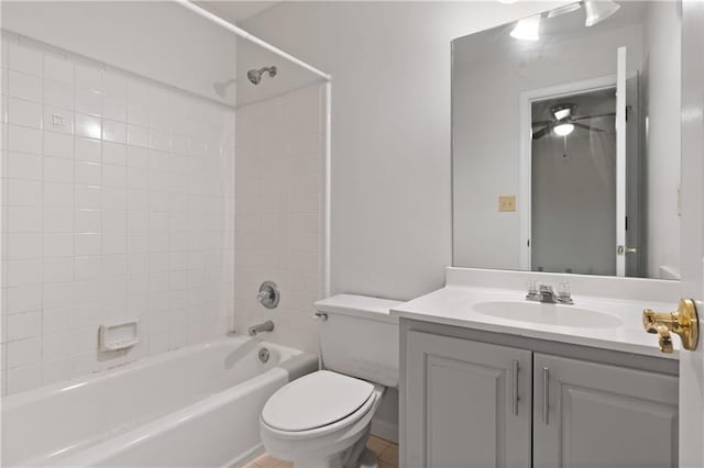 full bathroom featuring tiled shower / bath, vanity, and toilet