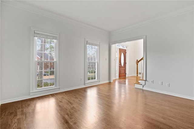 unfurnished room featuring wood-type flooring and ornamental molding