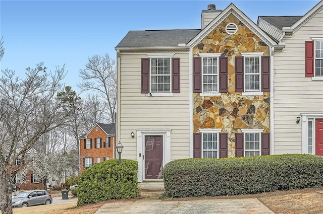 townhome / multi-family property featuring a chimney