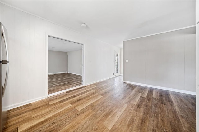 interior space with baseboards and wood finished floors