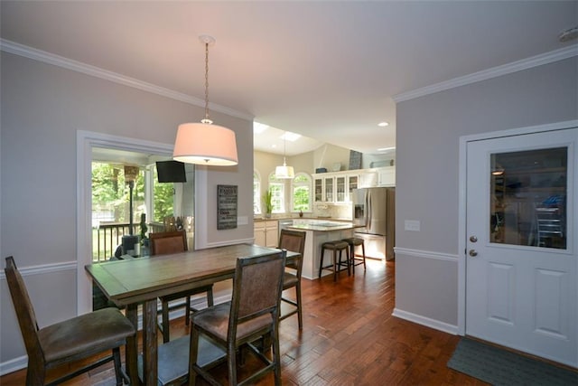dining space with crown molding, dark wood-type flooring, baseboards, and recessed lighting