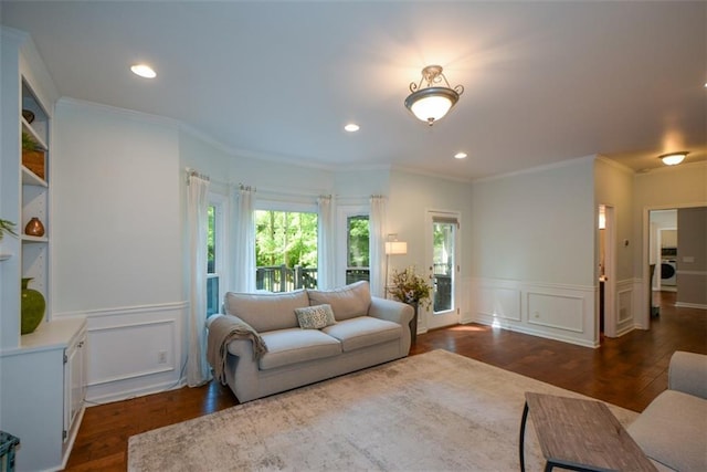 living room featuring dark wood-style flooring, a wainscoted wall, a decorative wall, washer / clothes dryer, and recessed lighting