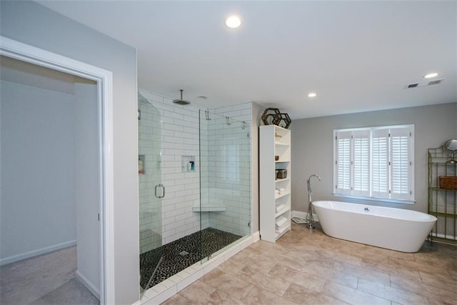 full bathroom featuring a shower stall, a freestanding bath, baseboards, and recessed lighting