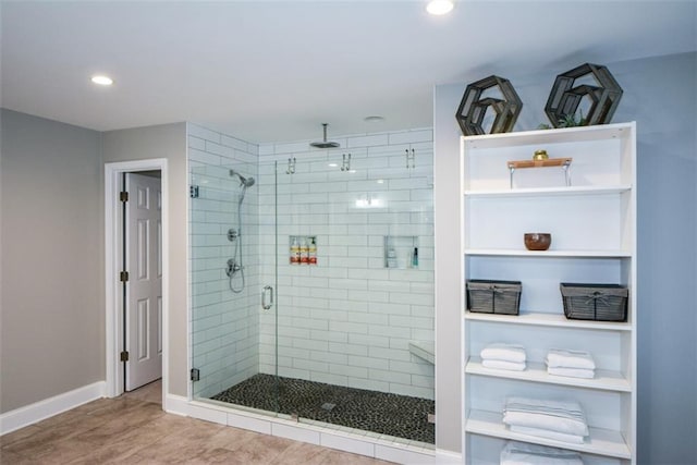 full bathroom featuring a stall shower, baseboards, wood finished floors, and recessed lighting