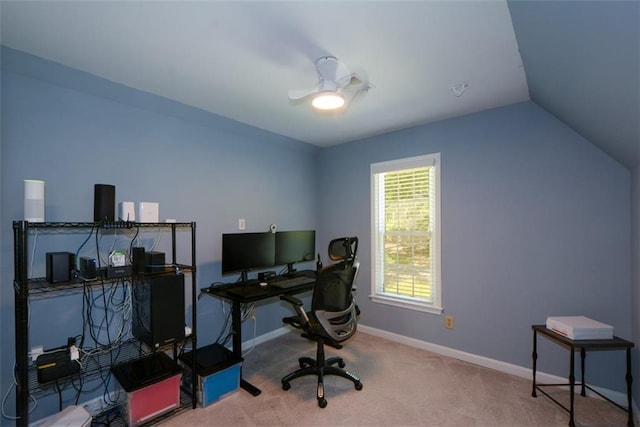 carpeted home office featuring baseboards and vaulted ceiling