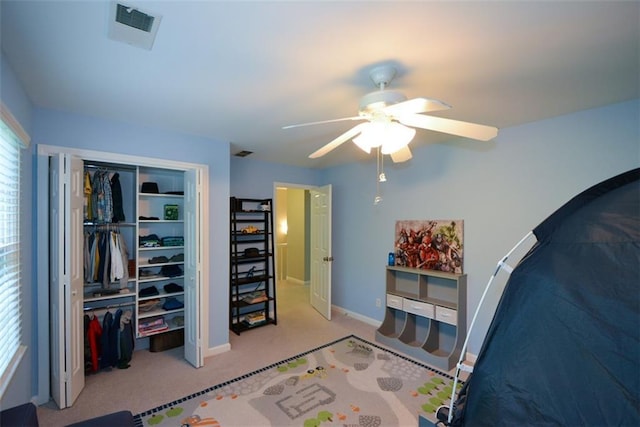 carpeted bedroom with baseboards, a closet, and ceiling fan