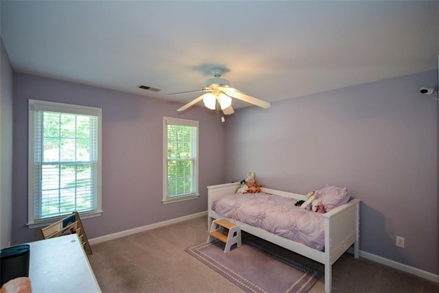 bedroom with carpet flooring, baseboards, and a ceiling fan