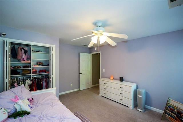 bedroom with carpet flooring, a closet, baseboards, and a ceiling fan