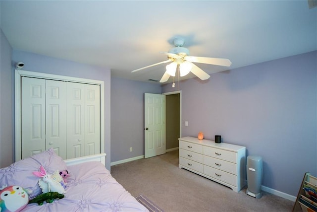 bedroom featuring carpet, a closet, baseboards, and ceiling fan