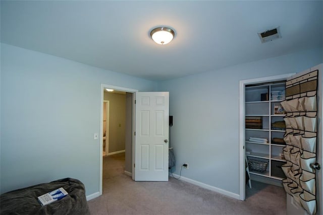 unfurnished bedroom featuring carpet floors, baseboards, and a closet
