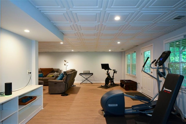 exercise area with recessed lighting, light wood finished floors, an ornate ceiling, and baseboards