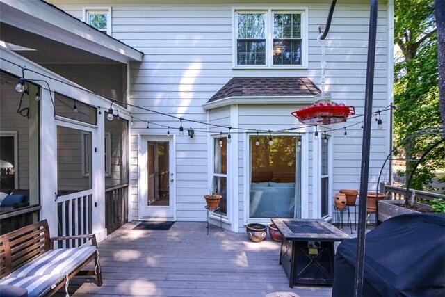 wooden deck featuring an outdoor fire pit