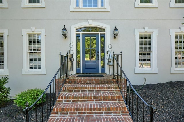 view of exterior entry featuring stucco siding
