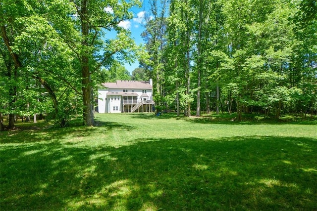 view of green lawn with stairway
