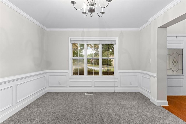 unfurnished dining area with a notable chandelier, carpet floors, visible vents, and crown molding