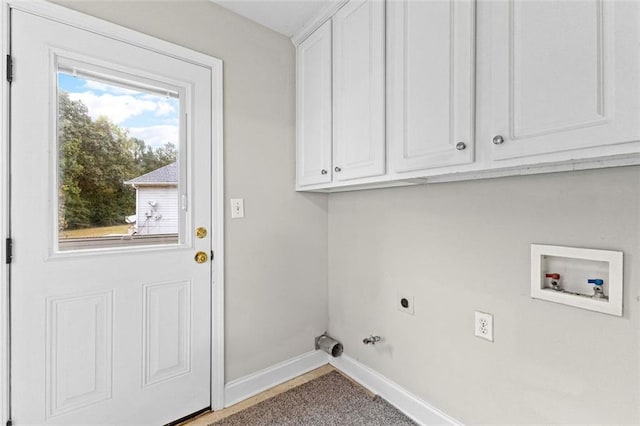 clothes washing area with gas dryer hookup, washer hookup, baseboards, cabinet space, and electric dryer hookup