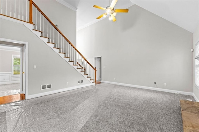 unfurnished living room featuring high vaulted ceiling, visible vents, baseboards, and stairs