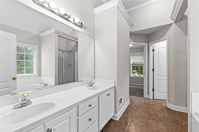 full bath with double vanity, plenty of natural light, and a sink