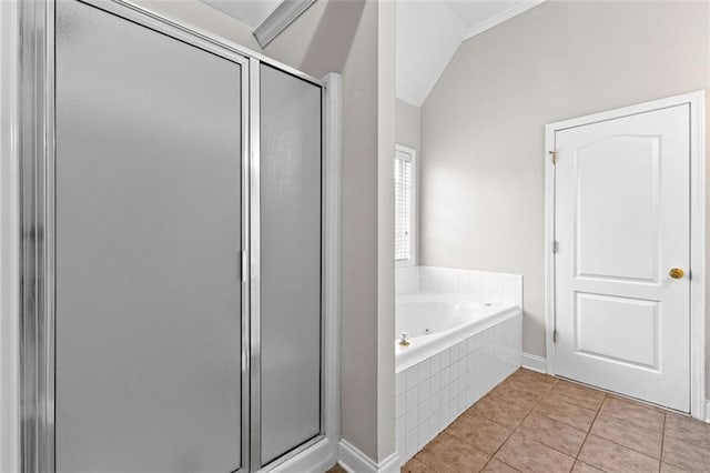 bathroom with a garden tub, vaulted ceiling, a shower stall, and tile patterned floors