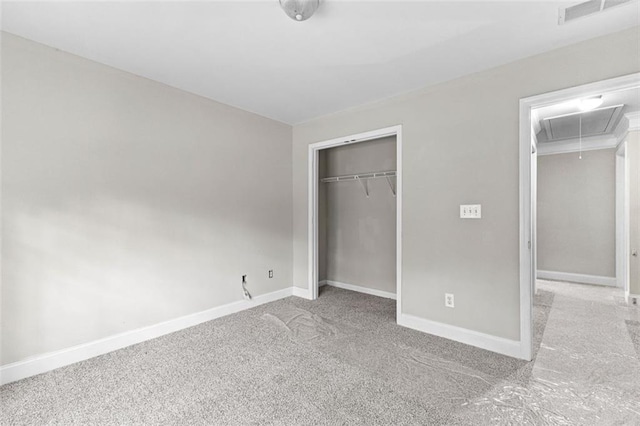 unfurnished bedroom with carpet flooring, visible vents, baseboards, a closet, and attic access