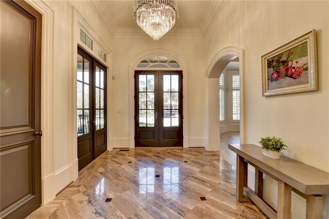 4505 Whitestone Way, Suwanee, GA 30024 - foyer featuring arched walkways, a notable chandelier, ornamental molding, french doors, and marble finish floor