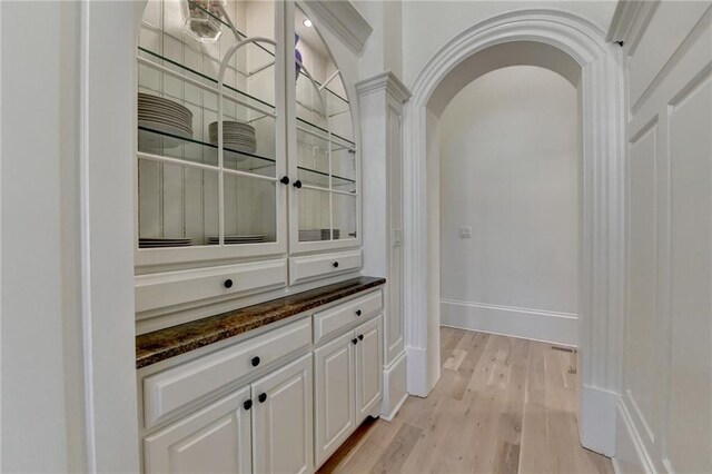 4505 Whitestone Way, Suwanee, GA 30024 - bar with arched walkways, light wood-style flooring, and baseboards