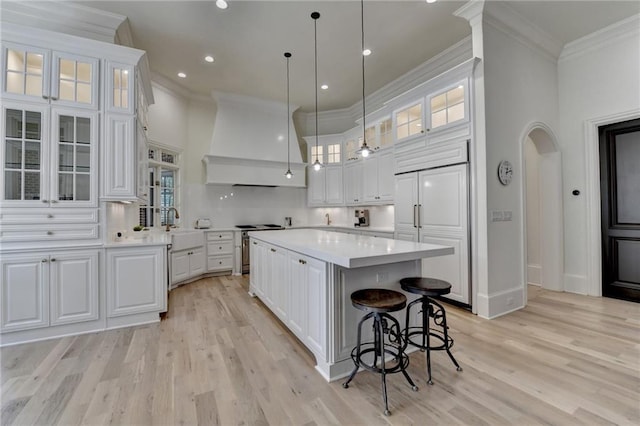 4505 Whitestone Way, Suwanee, GA 30024 - kitchen with custom exhaust hood, a towering ceiling, ornamental molding, and stainless steel range oven