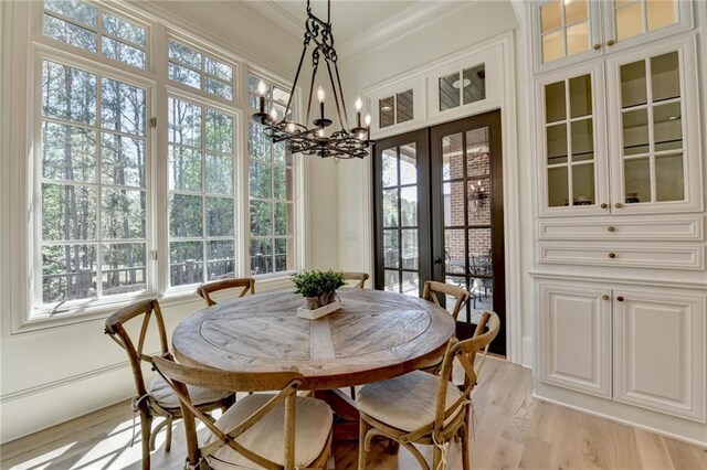 4505 Whitestone Way, Suwanee, GA 30024 - dining space with light wood finished floors, french doors, crown molding, and a healthy amount of sunlight