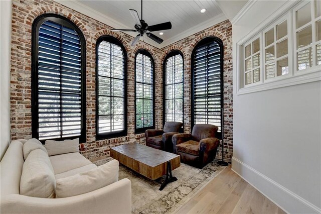 4505 Whitestone Way, Suwanee, GA 30024 - living area featuring ceiling fan, brick wall, wood finished floors, and baseboards