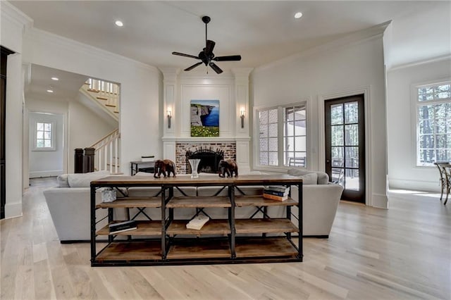 4505 Whitestone Way, Suwanee, GA 30024 - living area with a wealth of natural light, stairway, a brick fireplace, and light wood-type flooring