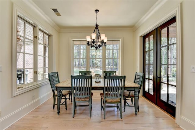 4505 Whitestone Way, Suwanee, GA 30024 - dining space featuring french doors, a wealth of natural light, light wood finished floors, and a notable chandelier