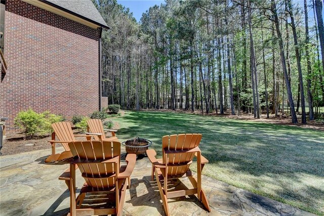 4505 Whitestone Way, Suwanee, GA 30024 - view of yard featuring a patio area, a forest view, and a fire pit