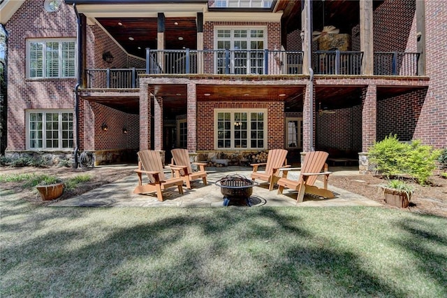 4505 Whitestone Way, Suwanee, GA 30024 - back of house featuring an outdoor fire pit, a patio, a balcony, and brick siding