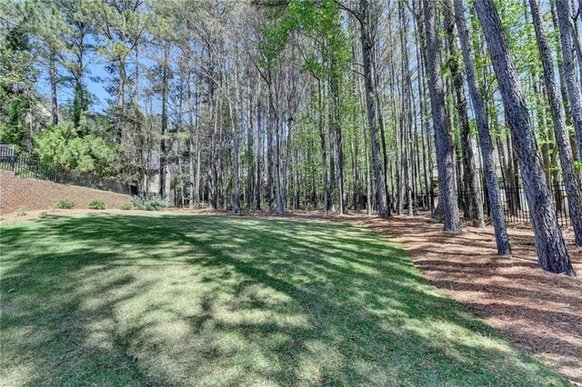 4505 Whitestone Way, Suwanee, GA 30024 - view of yard with a wooded view and fence