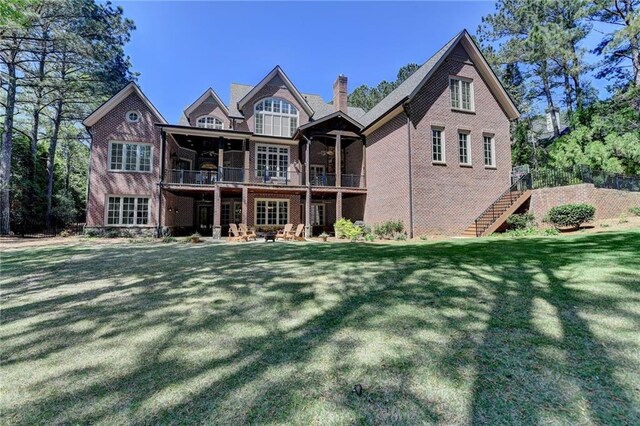 4505 Whitestone Way, Suwanee, GA 30024 - back of house with stairs, brick siding, a chimney, and a lawn