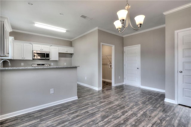 kitchen with dark wood-style floors, stainless steel microwave, white cabinetry, and baseboards