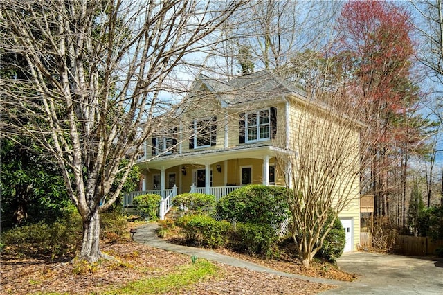 view of front of property featuring an attached garage, covered porch, and driveway